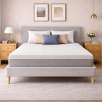 Gray upholstered bed with white mattress in a bedroom setting.